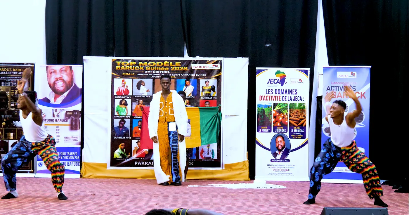 Le candidat n°9 en boubou blanc et jaune, un drapeau déployé derrière lui